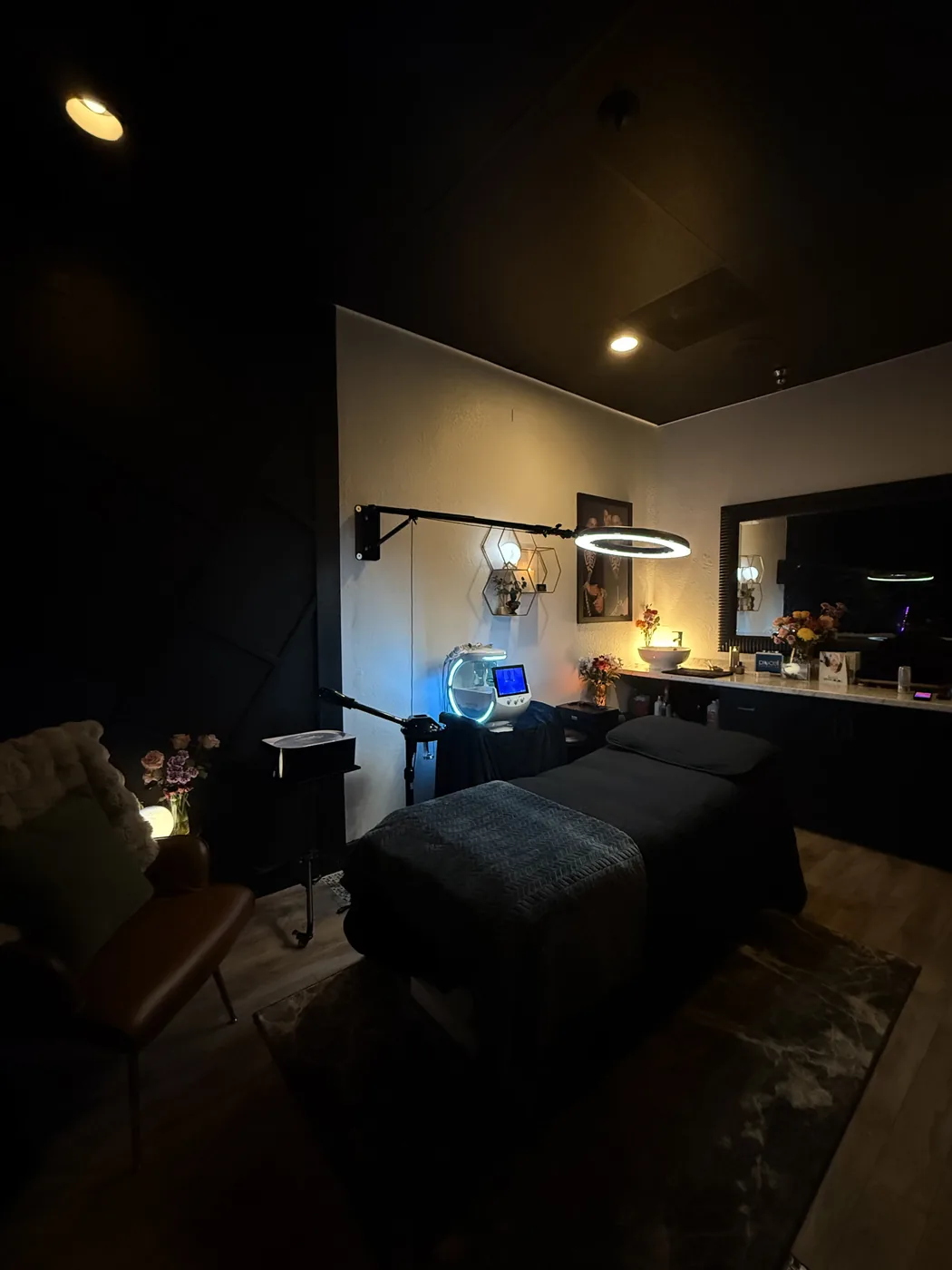 Softly lit treatment room with spa bed